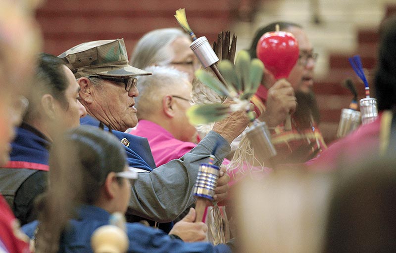 Group holding rattles during dance.