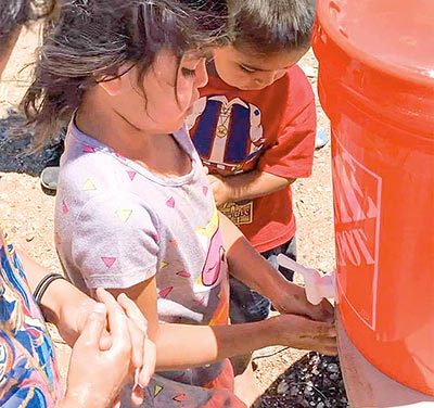 ‘Wash your hands’:  Group builds hand-washing kits for remote homes